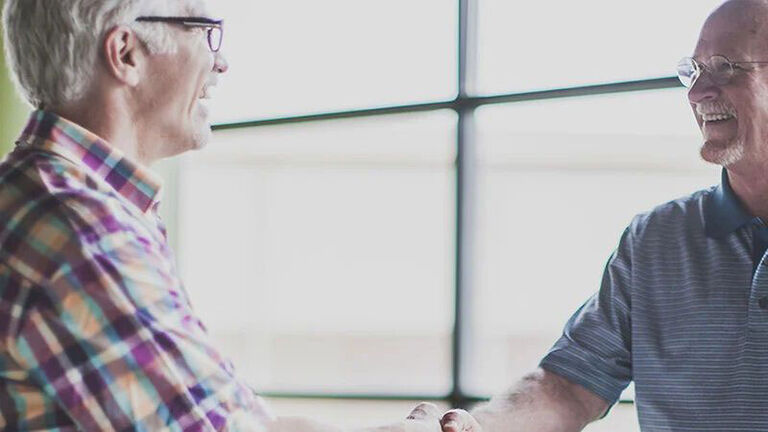 Two men share a pleasant conversation. 