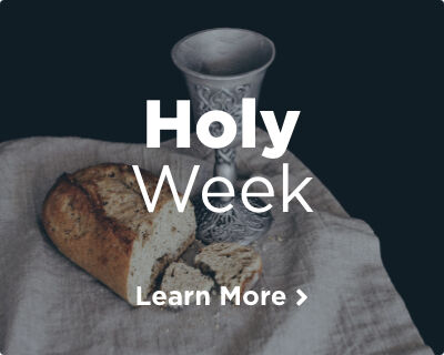 A silver chalice and a loaf of fresh bread, symbolizing the Body and Blood of Jesus, resting on a rustic white cloth. Image links to Holy Week page.