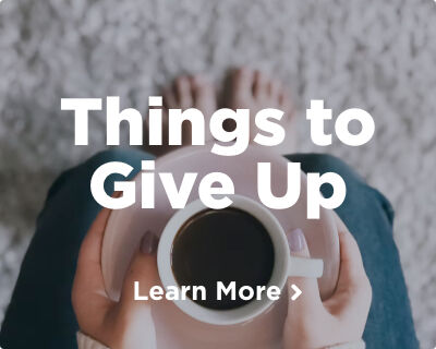 A woman's hands delicately holding a pink plate with a cup of coffee resting on it. Explore things to give up for Lent. Image links to a related page. 