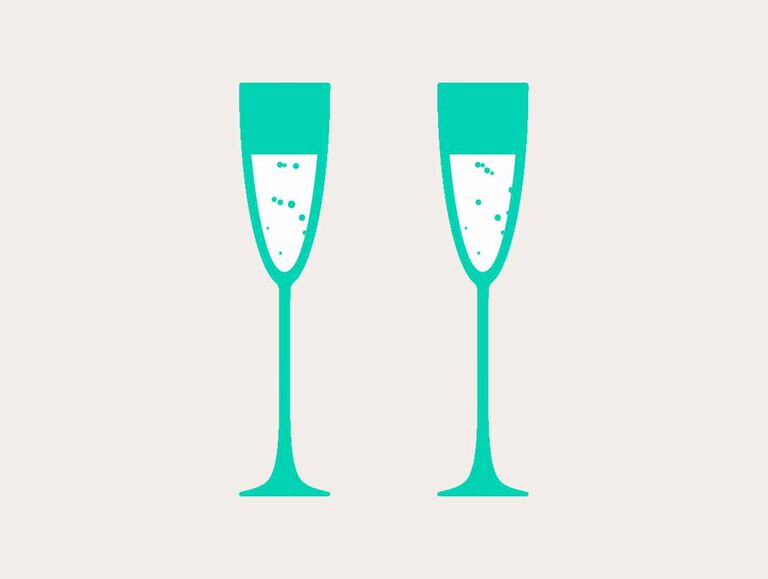 Two tall emerald green champagne glasses stand next to each other filled with a white and bubbly drink Two tall emerald green champagne glasses stand next to each other filled with a white and bubbly drink
