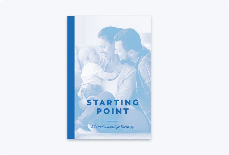 The front book cover with the title starting point in blue text sitting in the bottom third of the cover with the background of a wife sitting on the floor with her husband who is leaning over her left shoulder and smiling at their baby boy which the wife is holding up 